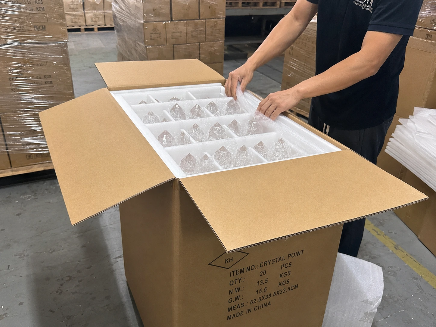 A large wholesale box being packed for sea freight, illustrating the cost-saving benefits of bulk shipping.