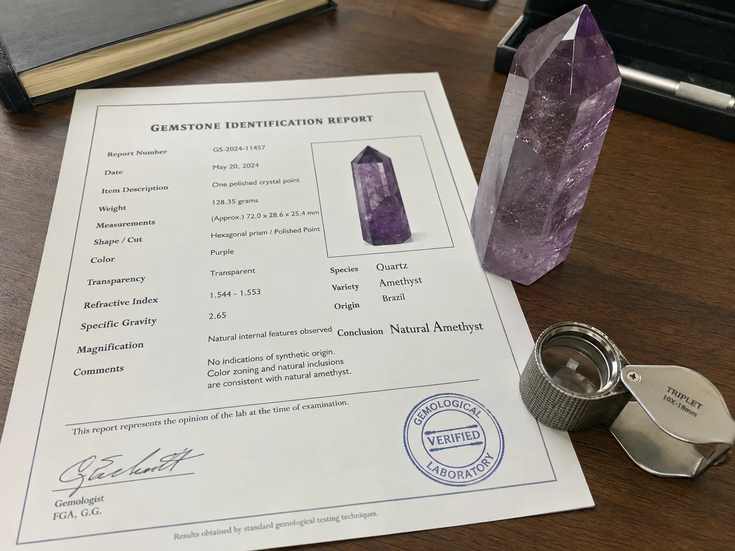 A gemstone testing report next to a natural crystal specimen.