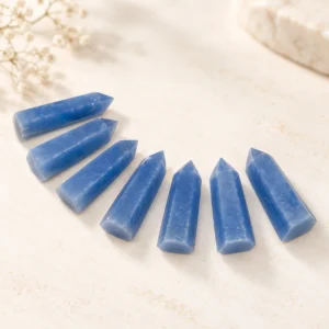 Blue crystal point towers arranged in a fan shape on a light minimal tabletop.