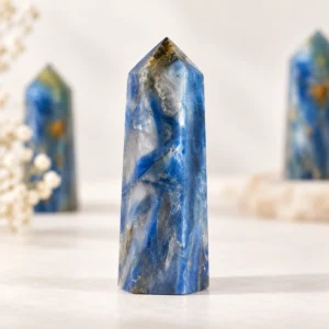 Blue and gold patterned crystal point towers arranged in a clean tabletop product scene.