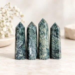 Green banded crystal tower points displayed in a clean product photo