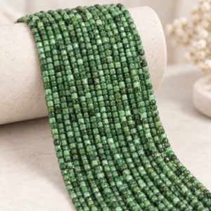 Wholesale Ruby Zoisite 4mm faceted cube bracelet bead strands displayed on a light minimalist tabletop.