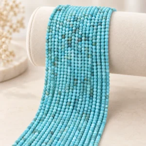 Wholesale Turquoise 4mm faceted cube bracelet bead strands displayed on a light minimalist tabletop.