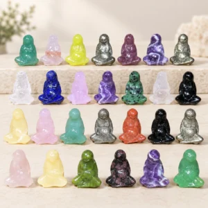 Assorted natural crystal Earth Mother carvings in multiple colors on a light minimalist tabletop