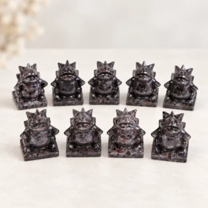 Fire quartz fantasy monster character crystal carvings arranged in rows on a light minimalist tabletop