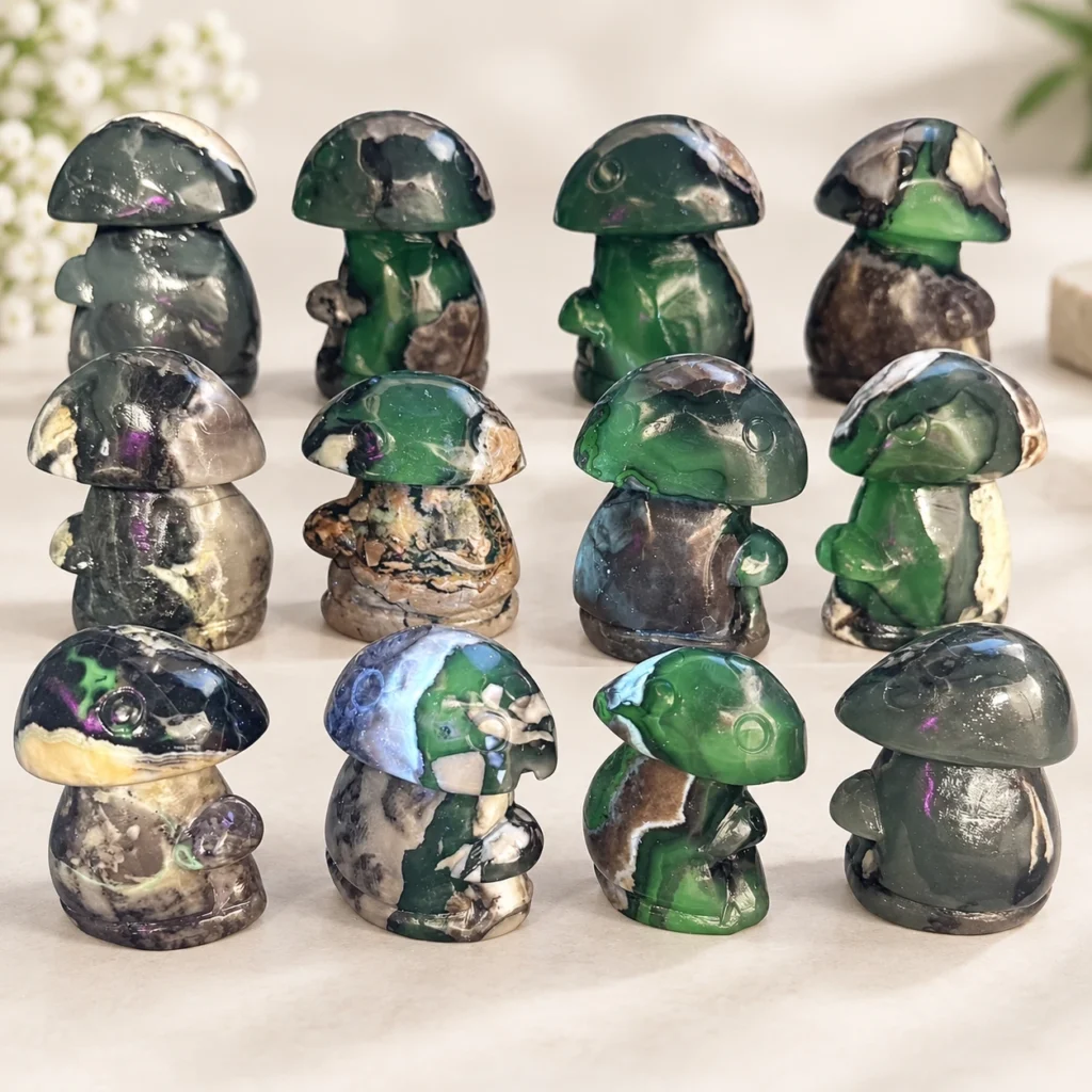 Mixed fire quartz mushroom crystal carvings with green and dark natural stone patterns on a light tabletop