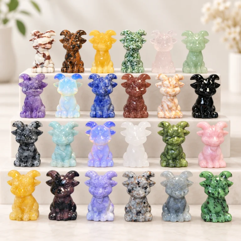 Assorted natural crystal goat carvings in multiple stone colors displayed on a light minimalist tabletop