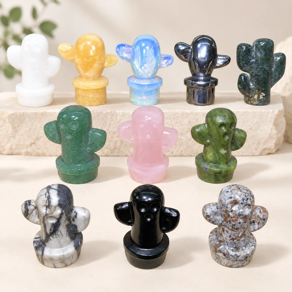 Assorted mixed material cactus crystal carvings displayed on a light minimalist tabletop