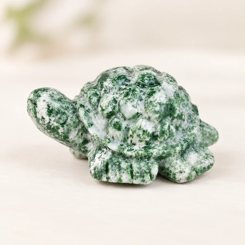 Mixed Material Turtle Crystal Carving on a light minimalist tabletop background