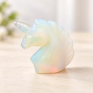 Mixed Material Unicorn Crystal Carving on a light minimalist tabletop background