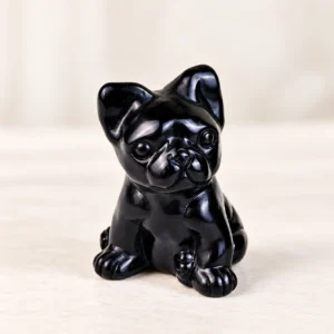 Obsidian French Bulldog Crystal Carving on a light minimalist tabletop background