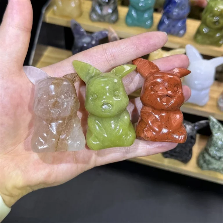 Assorted natural crystal cartoon mouse carvings including yellow green and red stone figures